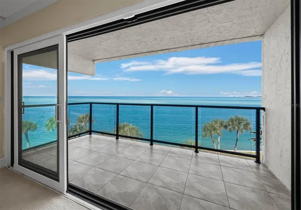 a kitchen with stainless steel appliances granite countertop a stove top oven a sink dishwasher a refrigerator and white cabinets with wooden floor