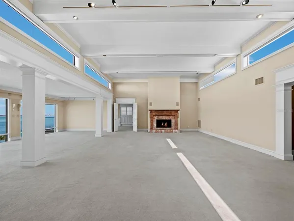 a view of a room with gym equipment and large windows