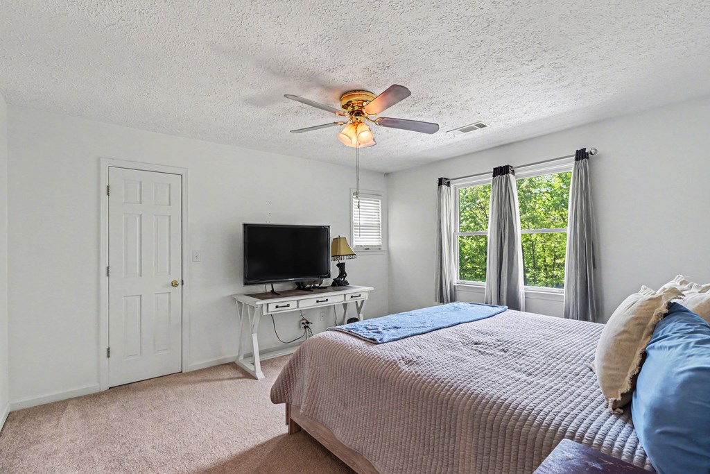 1136 Timber Ridge Lane Ellijay, GA 30540 - Photo 21 of 36 a bedroom with a bed and a flat screen tv