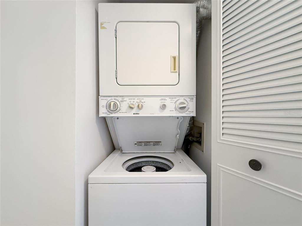 1308 Pine Ridge Circle East, Unit H2 Tarpon Springs, FL 34688 - Photo 12 of 17 a utility room with dryer and washer