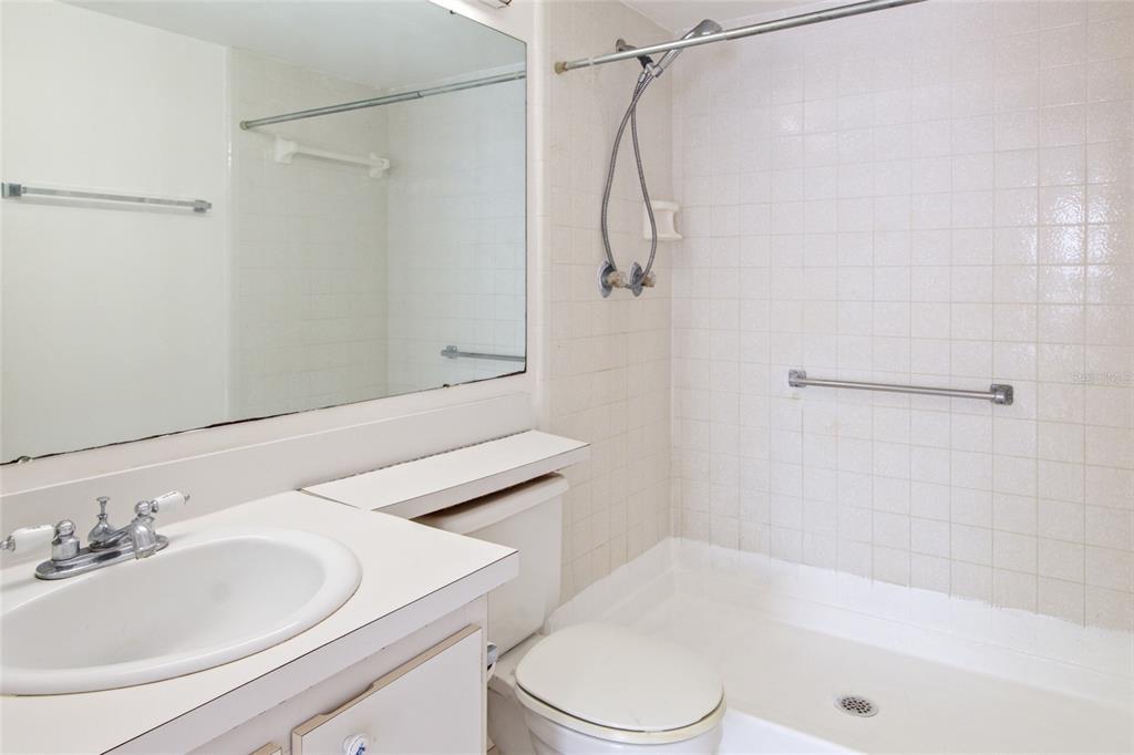 1308 Pine Ridge Circle East, Unit H2 Tarpon Springs, FL 34688 - Photo 9 of 17 a bathroom with a sink a toilet and shower