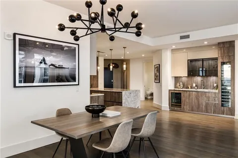 a view of a dining room with furniture wooden floor and a chandelier