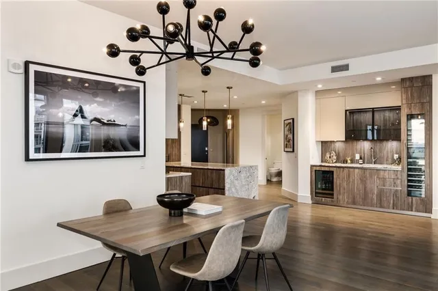 a view of a dining room with furniture wooden floor and a chandelier