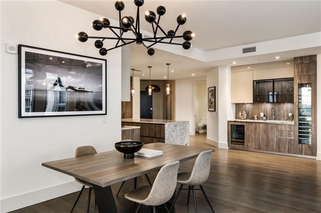 3107 Peachtree Road Northeast, Unit 1803 Atlanta, GA 30305 - Photo 14 of 45 a view of a dining room with furniture wooden floor and a chandelier