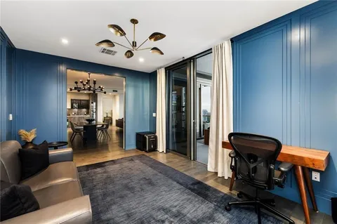 a view of a livingroom with furniture and gym equipment