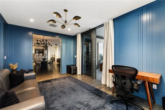 a view of a livingroom with furniture and gym equipment