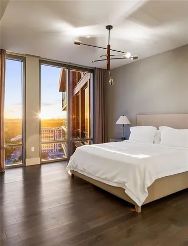 a bedroom with a large bed and a large window