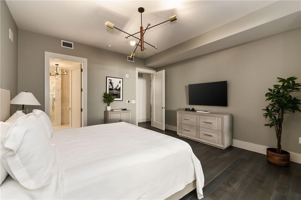3107 Peachtree Road Northeast, Unit 1803 Atlanta, GA 30305 - Photo 21 of 45 a bedroom with a bed and a flat screen tv