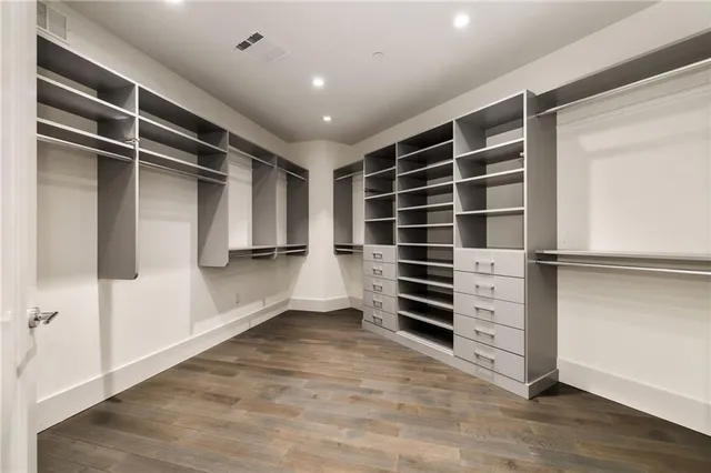 a view of walk in closet with empty racks