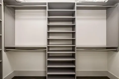 a view of walk in closet with empty racks