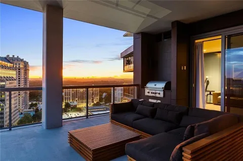 a living room with furniture and a floor to ceiling window