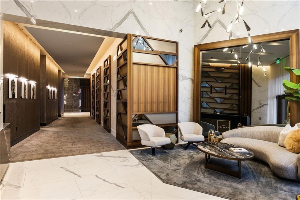 3107 Peachtree Road Northeast, Unit 1803 Atlanta, GA 30305 - Photo 44 of 45 a living room with furniture and a flat screen tv