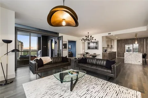 a living room with furniture and a mirror