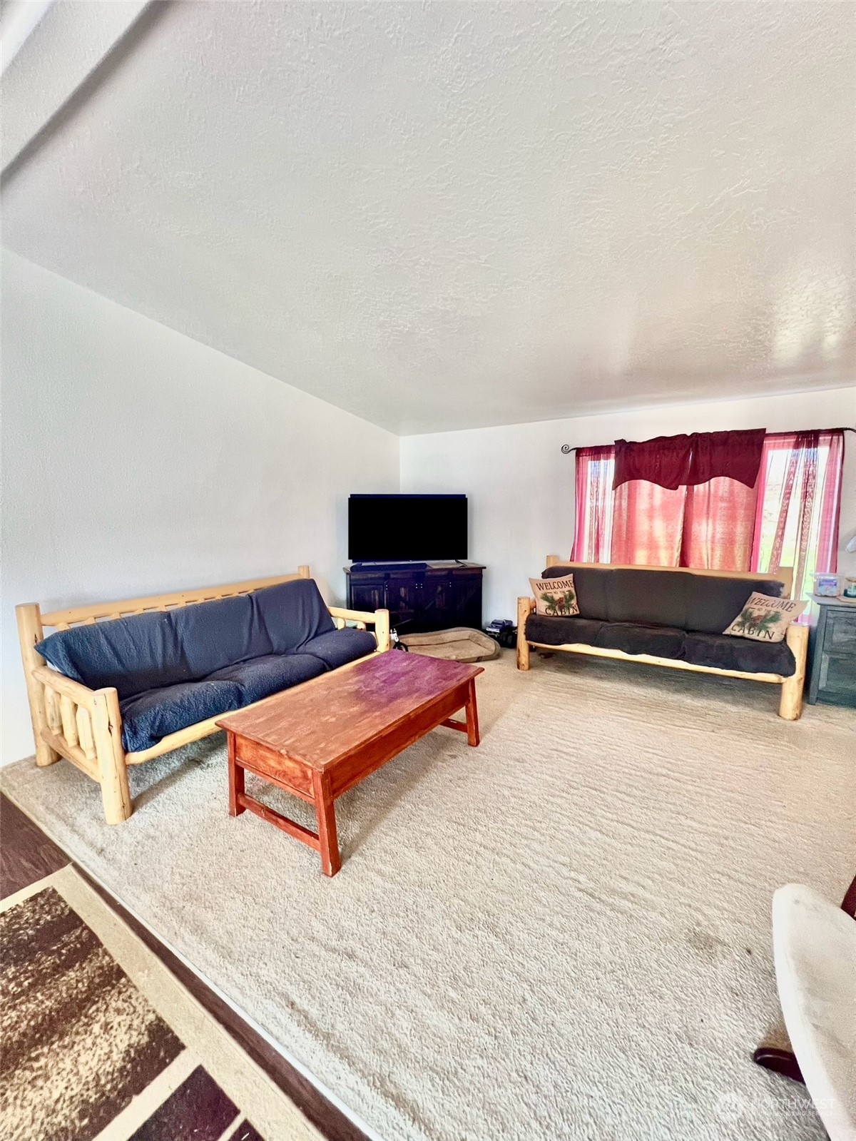 256 C Riverside Cutoff Road Riverside, WA 98849 - Photo 18 of 36 a living room with furniture and a flat screen tv