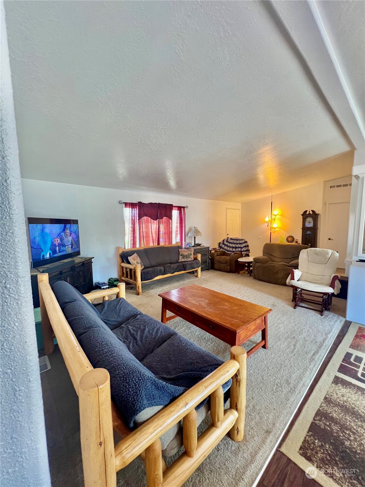 256 C Riverside Cutoff Road Riverside, WA 98849 - Photo 19 of 36 a living room with furniture and a flat screen tv
