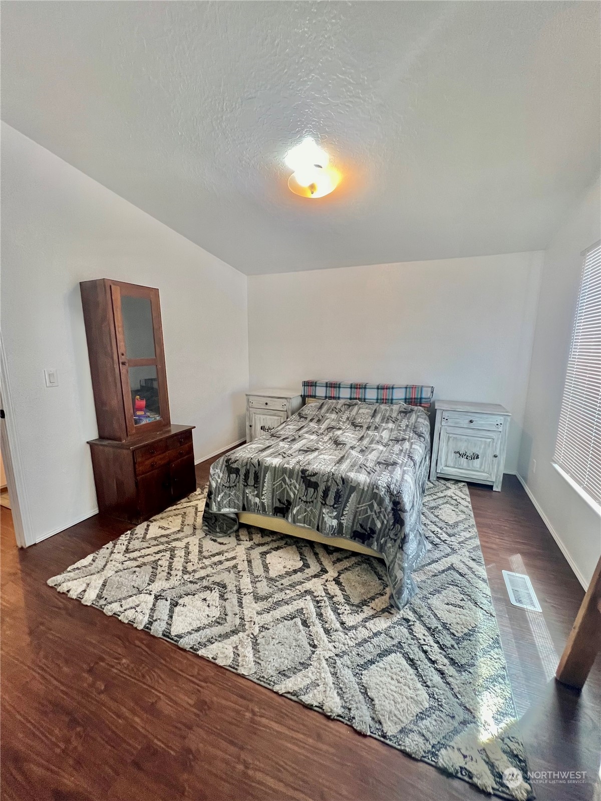 256 C Riverside Cutoff Road Riverside, WA 98849 - Photo 26 of 36 a bedroom with a bed and a mirror