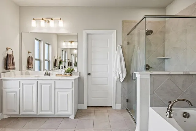 a bathroom with a granite countertop sink a mirror and a shower