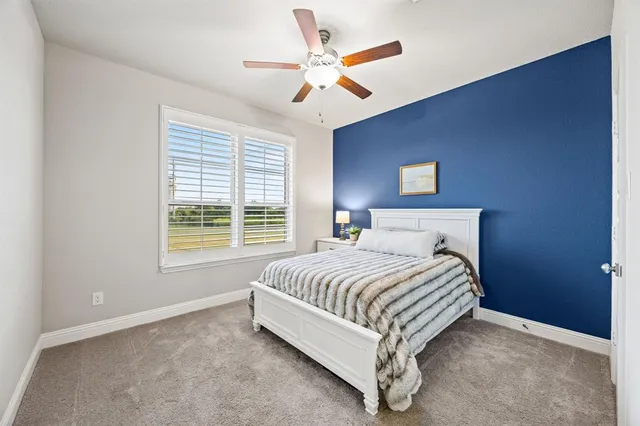 a large bed sitting in a bedroom next to a window