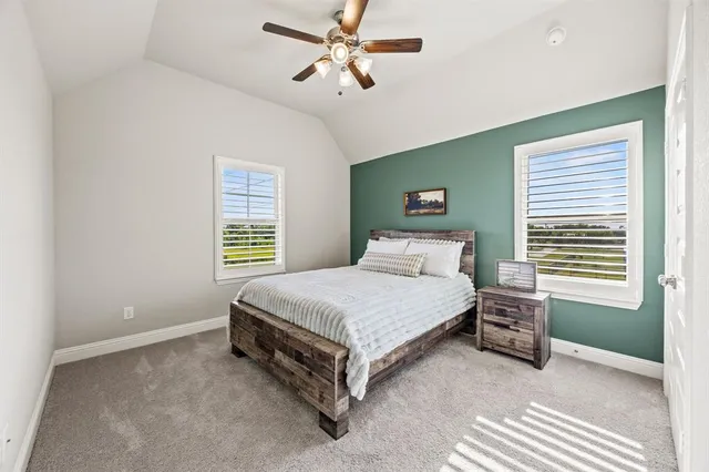a bathroom with a sink a toilet and a large mirror