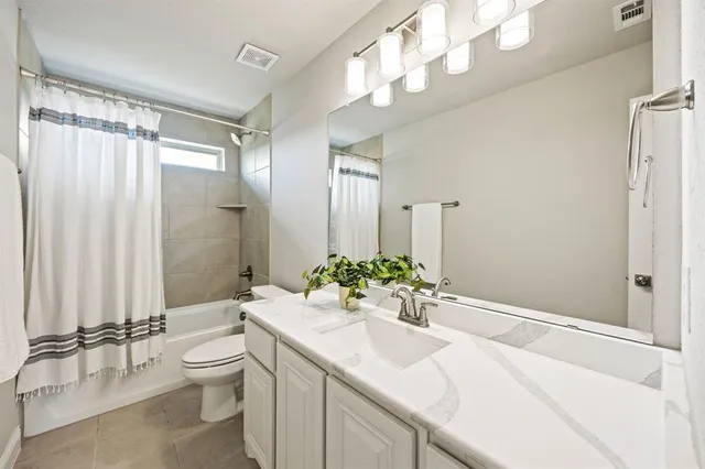 a view of a house with a big yard and large trees