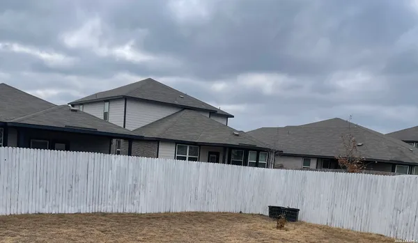 a house that has a big tree in front of it