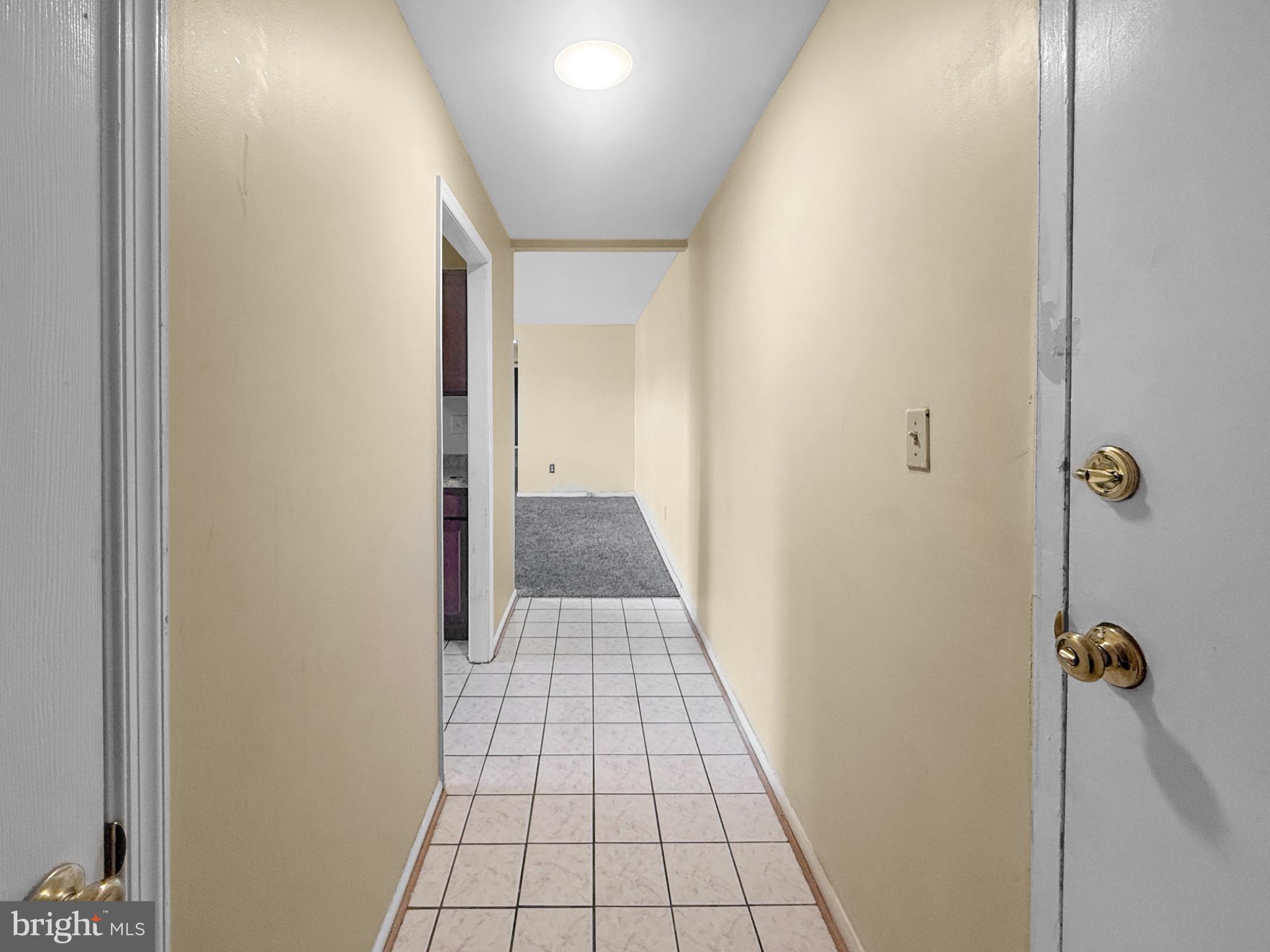3807 St Barnabas Road, Unit 203 Suitland, MD 20746 - Photo 2 of 23 Inviting hallway with warm tones.