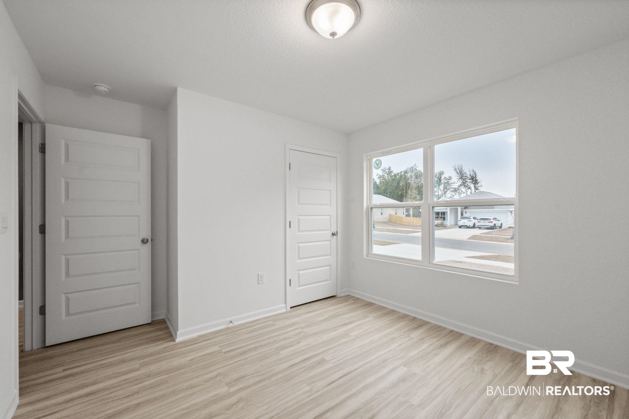 16272 Laurelbrooke Loop Fairhope, AL 36532 - Photo 18 of 40 Unfurnished bedroom with light hardwood / wood-style flooring and a closet