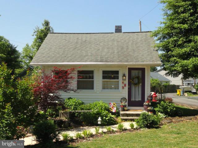 403 Paradise Road Riva, MD 21140 - Photo 1 of 22 a front view of a house with a yard and potted plants