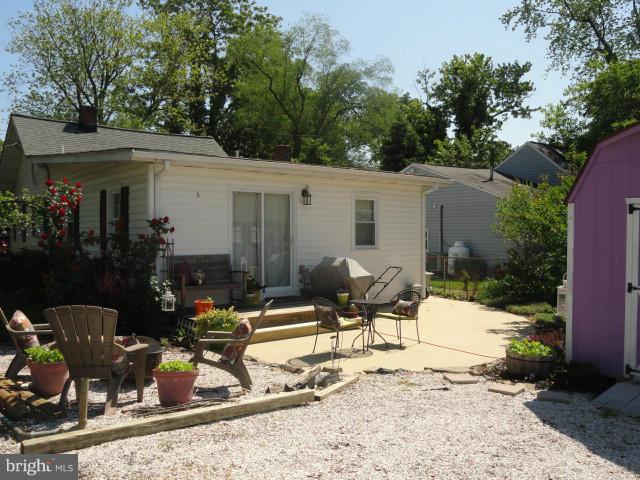 403 Paradise Road Riva, MD 21140 - Photo 2 of 22 a view of a patio with chair and tables back yard of the house
