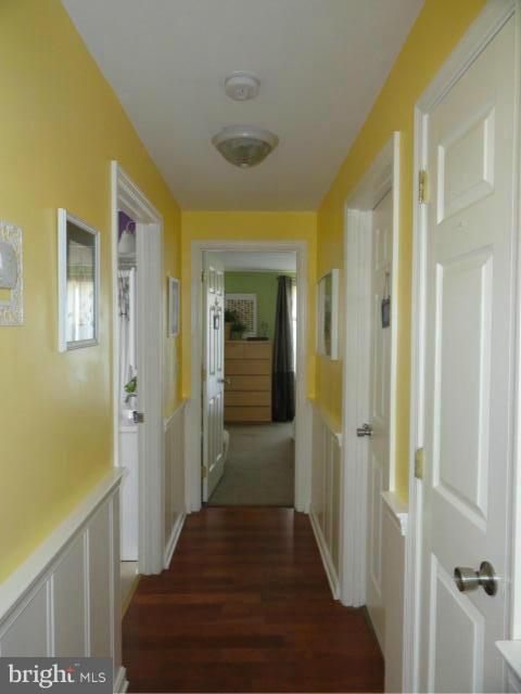 403 Paradise Road Riva, MD 21140 - Photo 14 of 22 a view of a hallway with wooden floor and staircase