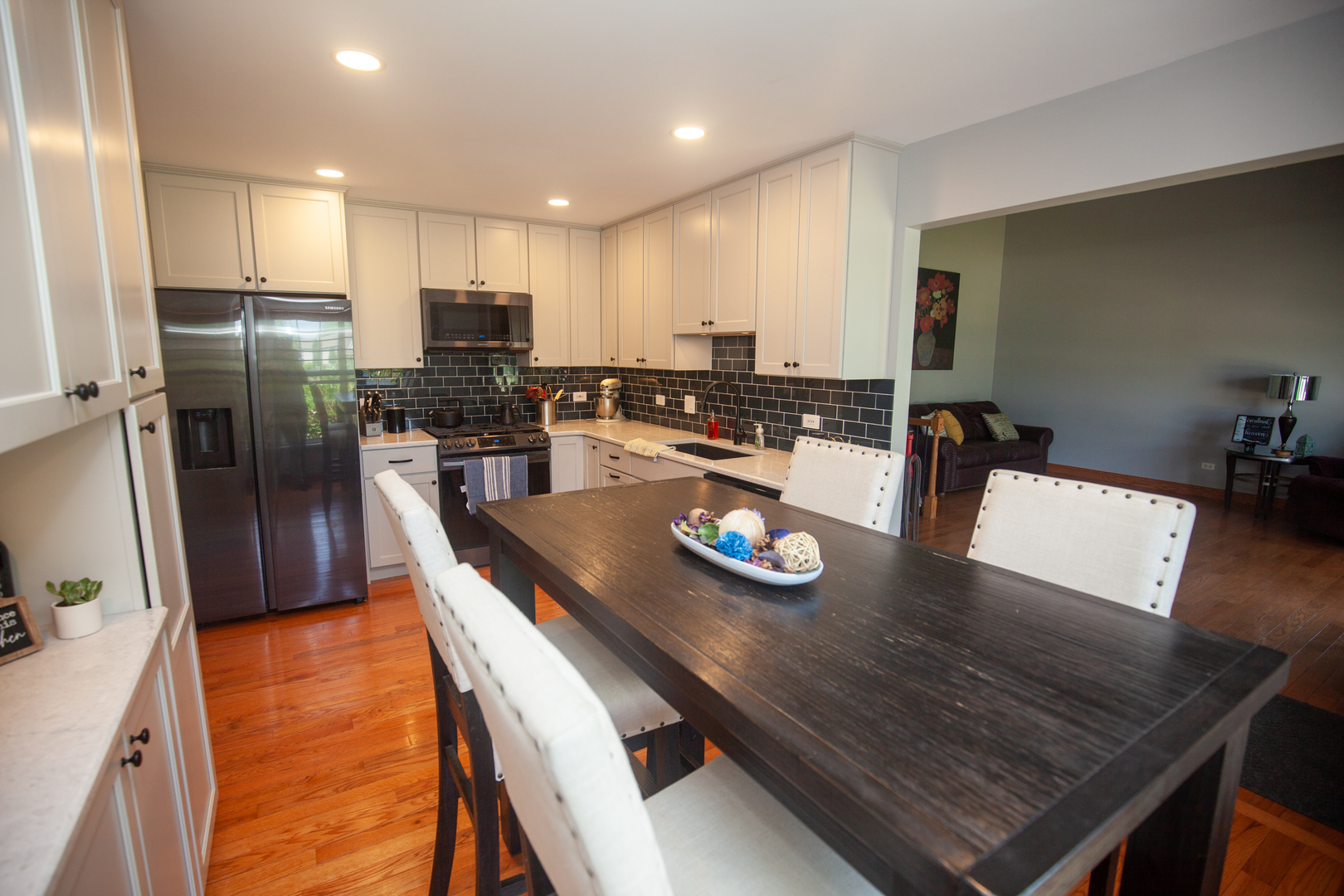 613 Cartwright Trail McHenry, IL 60050 - Photo 2 of 23 a kitchen with refrigerator and wooden floor