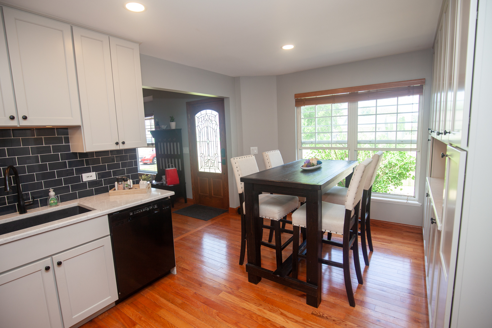 613 Cartwright Trail McHenry, IL 60050 - Photo 3 of 23 a kitchen with stainless steel appliances granite countertop a table chairs sink and cabinets