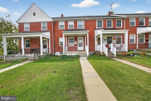 front view of a brick house with a yard