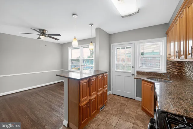 a kitchen with granite countertop a stove and a sink