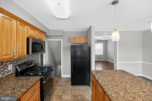 a kitchen with a stove and a refrigerator