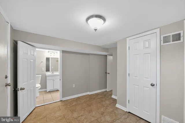 a view of a room with an empty space and wooden floor