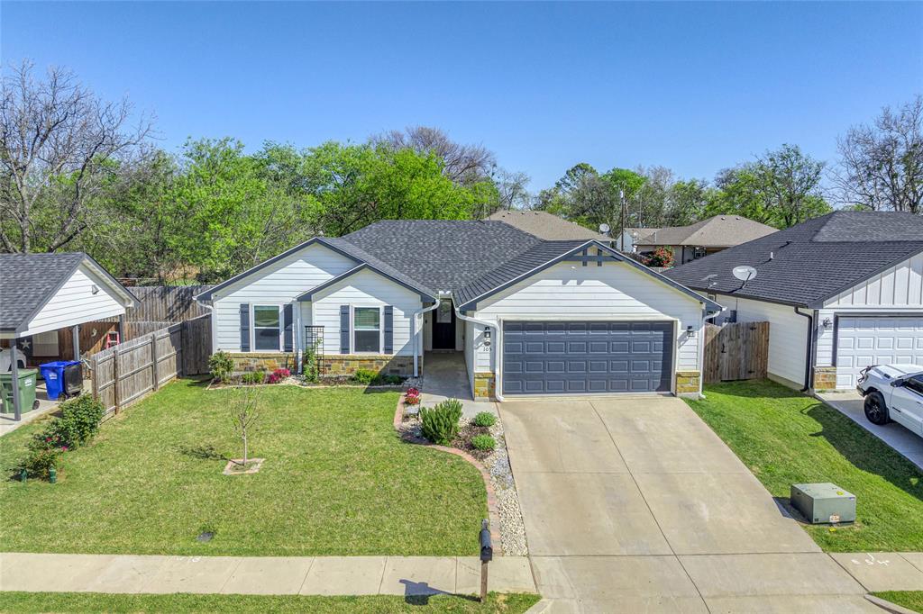 105 Thode Street Whitesboro, TX 76273 - Photo 1 of 28 a house view with a garden space