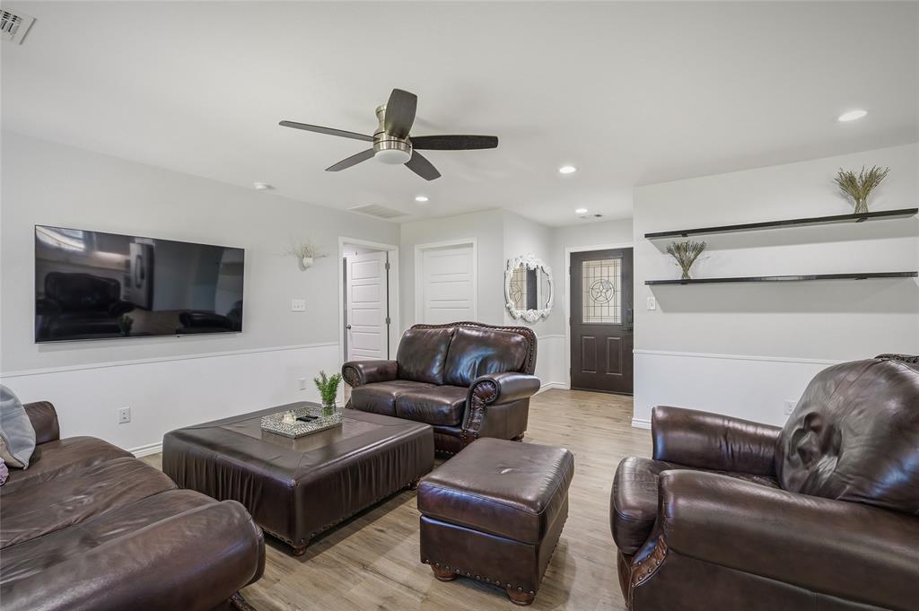 105 Thode Street Whitesboro, TX 76273 - Photo 11 of 28 a living room with furniture and a flat screen tv