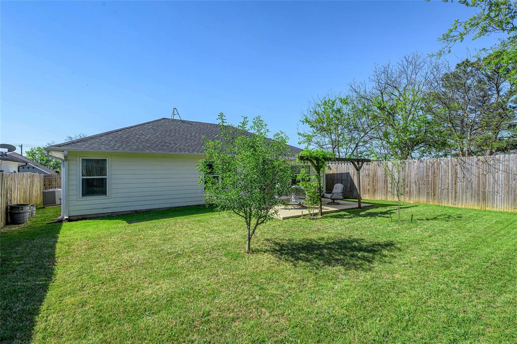 105 Thode Street Whitesboro, TX 76273 - Photo 24 of 28 a backyard of a house with table and chairs