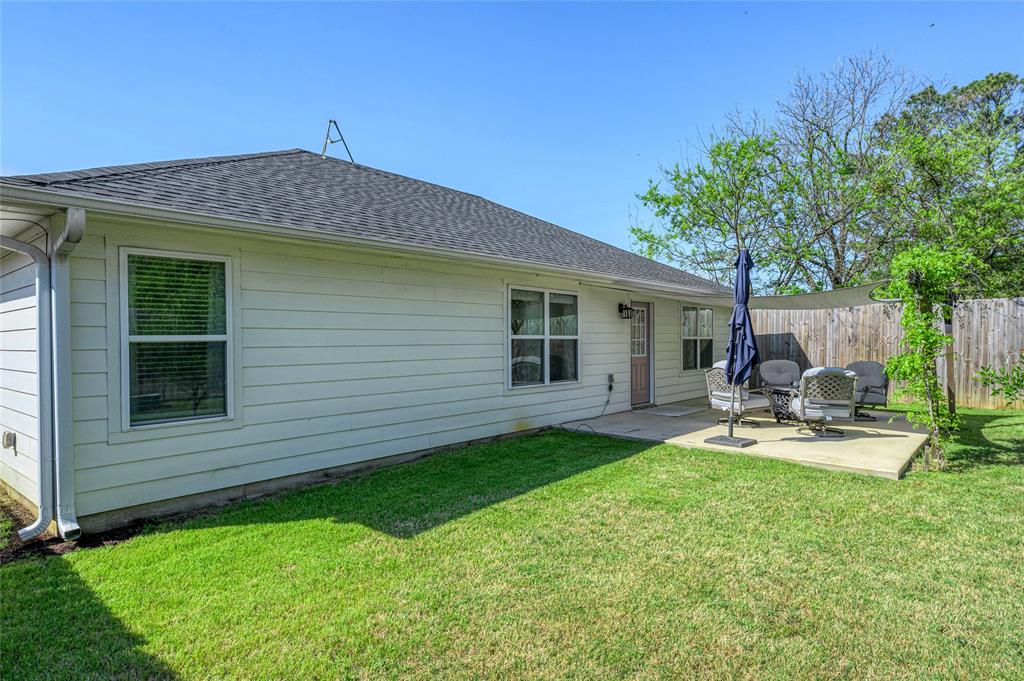 105 Thode Street Whitesboro, TX 76273 - Photo 25 of 28 a view of a backyard with table and chairs and a barbeque