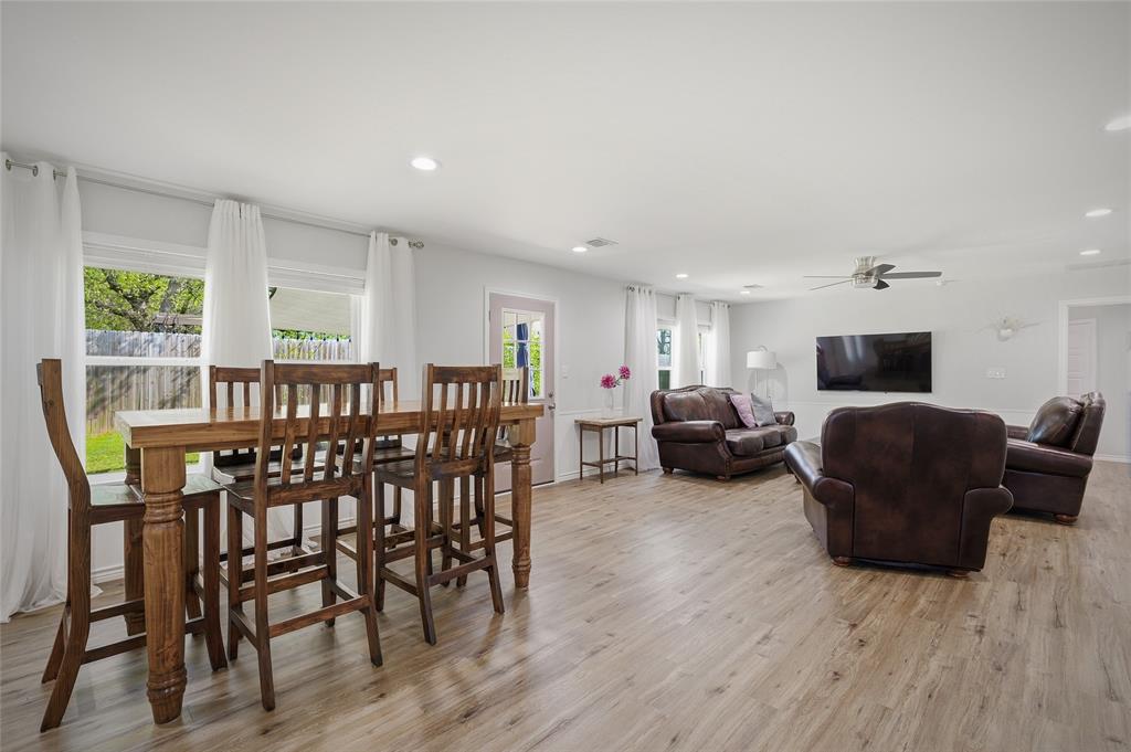 105 Thode Street Whitesboro, TX 76273 - Photo 3 of 28 a living room with furniture a wooden floor and a flat screen tv