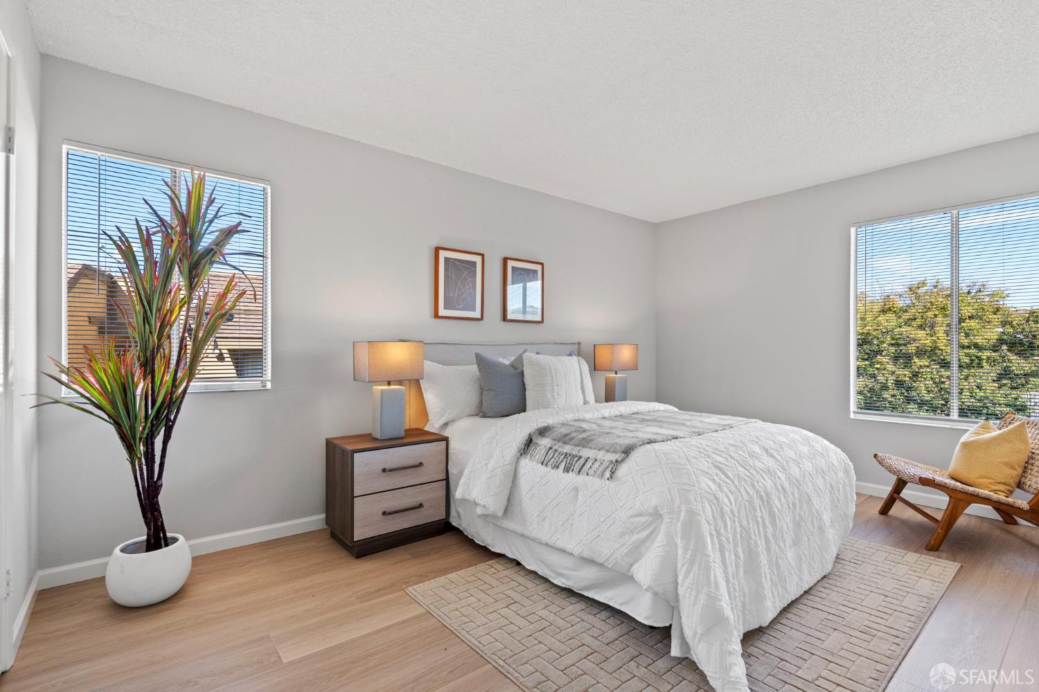 5319 Ridgeview Circle, Unit 10 El Sobrante, CA 94803 - Photo 12 of 26 a bedroom with a large bed and a potted plant