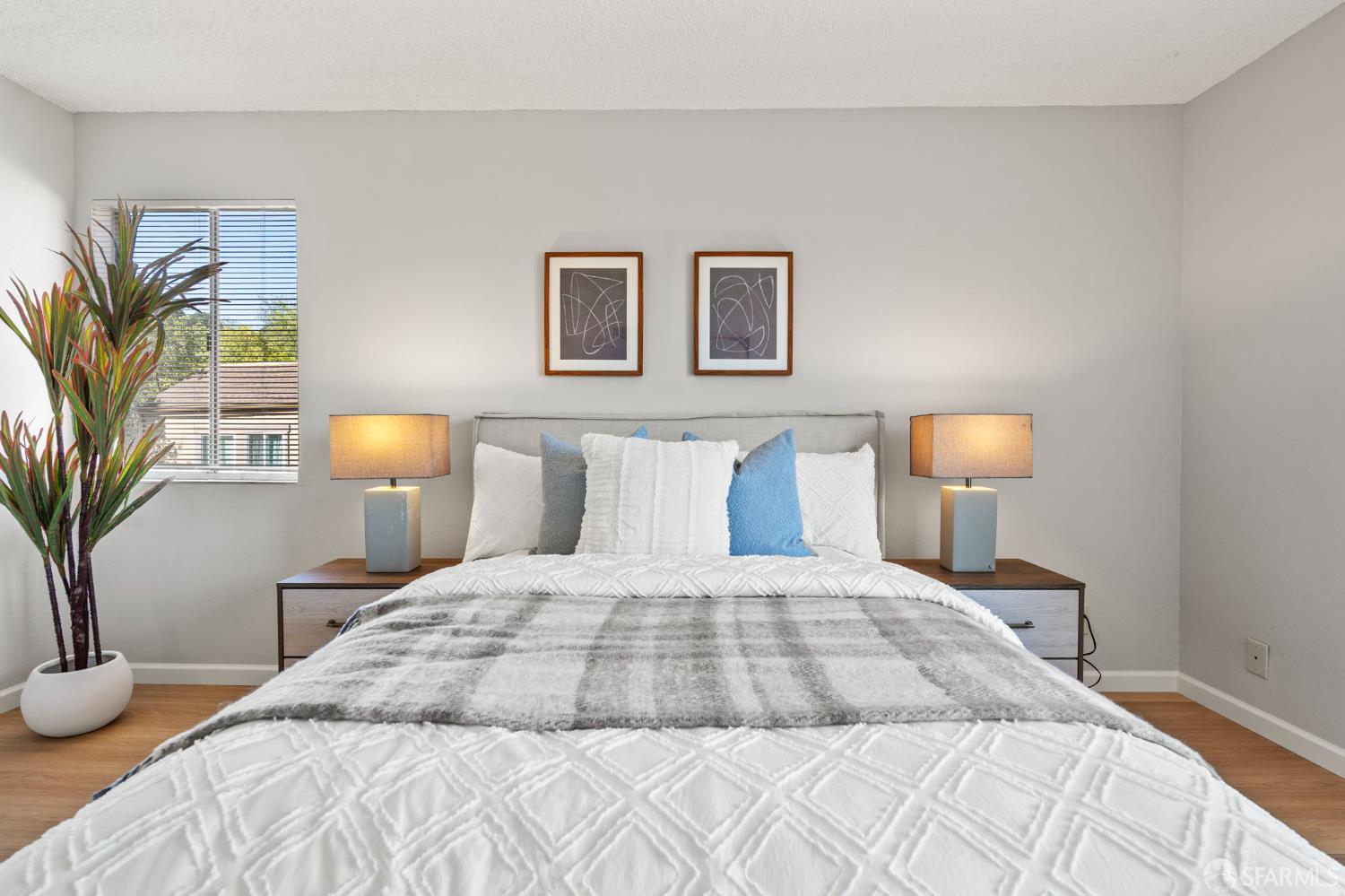 5319 Ridgeview Circle, Unit 10 El Sobrante, CA 94803 - Photo 13 of 26 a bedroom with a bed and a lamp with potted plant