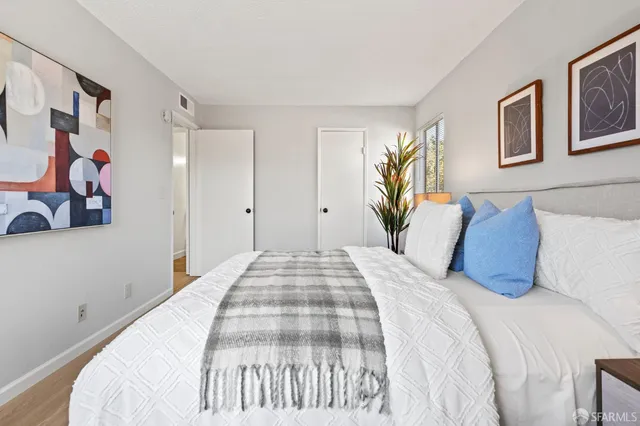 a bedroom with a large bed and a chandelier