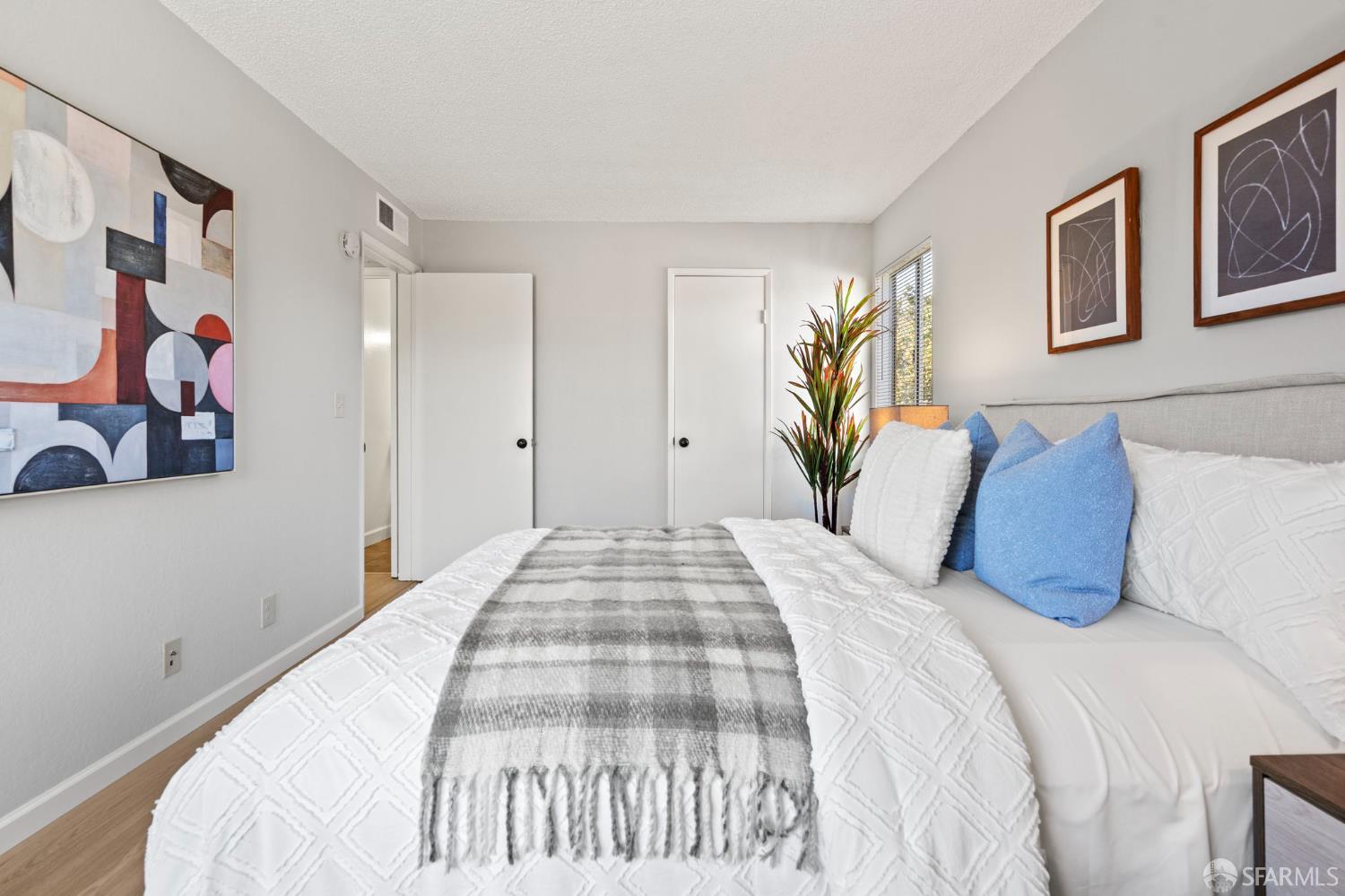 5319 Ridgeview Circle, Unit 10 El Sobrante, CA 94803 - Photo 14 of 26 a bedroom with a large bed and a chandelier