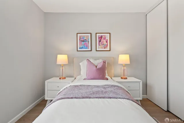 a bedroom with a bed and a lamp on table