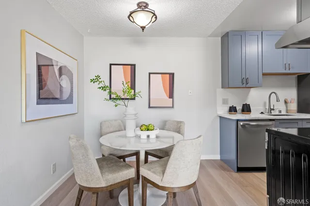 a view of a dining room with furniture wooden floor and a chandelier