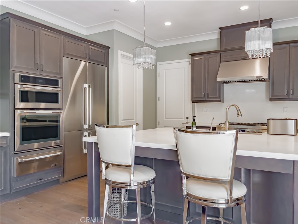 58 Riverboat Irvine, CA 92602 - Photo 13 of 72 a kitchen with a dining table chairs and refrigerator