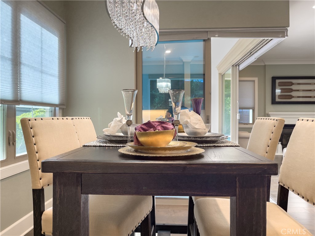 58 Riverboat Irvine, CA 92602 - Photo 19 of 72 a view of a dining room with furniture wooden floor and chandelier