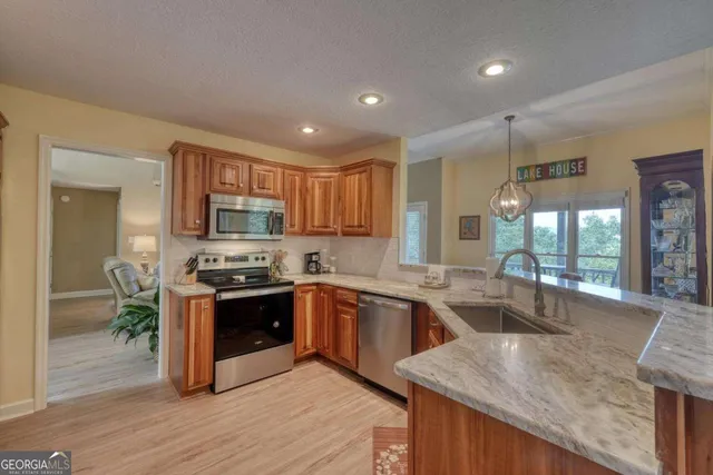 a bathroom with a granite countertop sink toilet and mirror